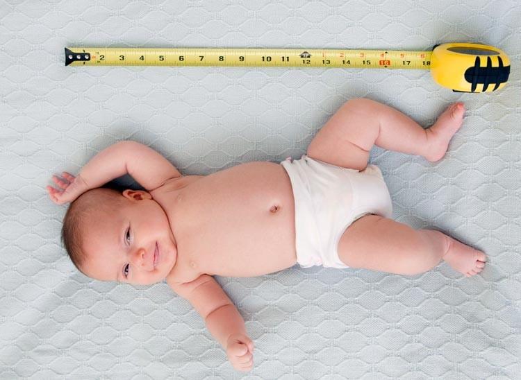 Измерение длины тела младенца в возрасте нескольких месяцев